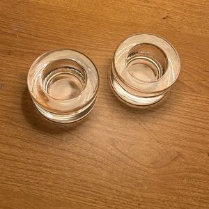 Two glass candle holders for tea lights or votive candles.